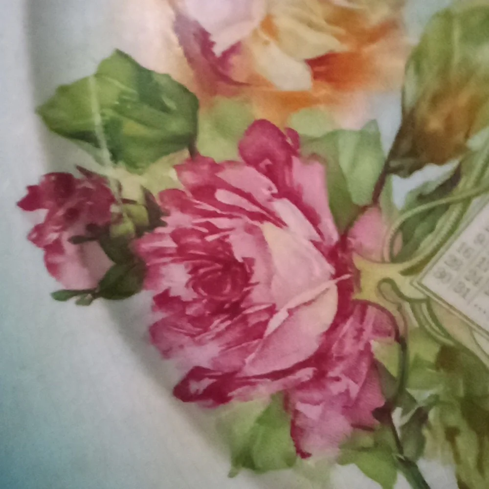 Hand painted calendar advertising plate from 1910. Turquoise & roses